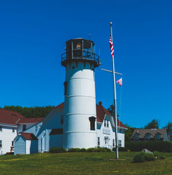 Low angle view of lighthouse on field against sky