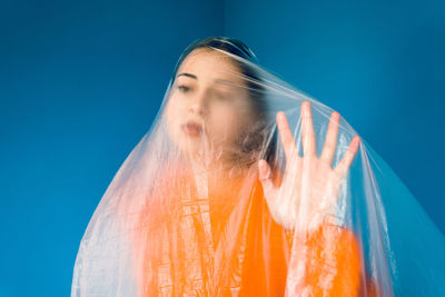 Portrait of woman against blue sky