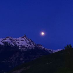 Scenic view of mountains against blue sky