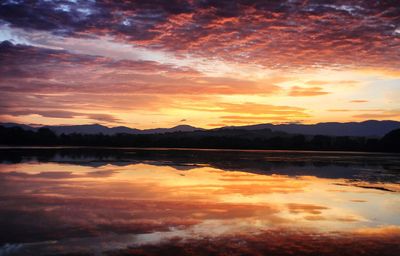 Scenic view of lake against romantic sky at sunset