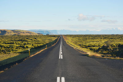 Road amidst landscape against sky