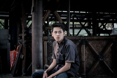 Portrait of young man sitting outdoors