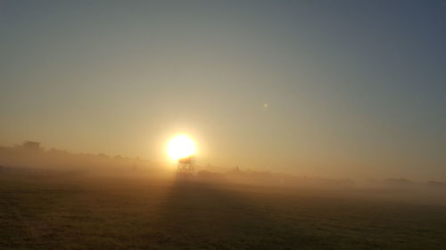 Scenic view of field against sky during sunset