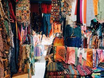 Multi colored fabrics hanging at market stall