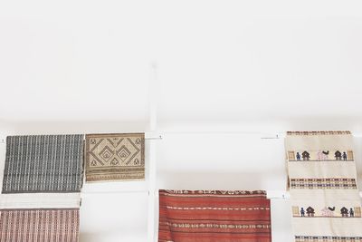 Low angle view of woven fabric on white wall