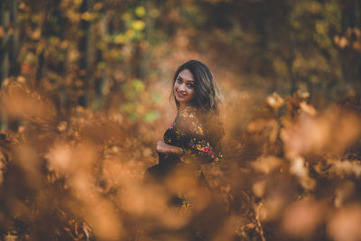 Portrait of smiling young woman standing outdoors