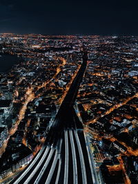 High angle view of illuminated city against sky at night