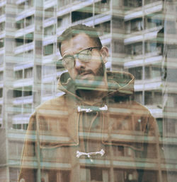 Man seen through glass window with reflection