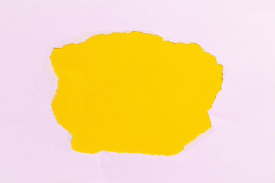 Close-up of yellow paper against white background