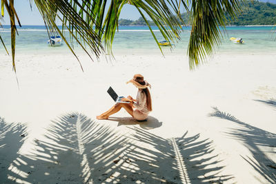 Young woman sitting on beach