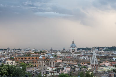 Cityscape against cloudy sky