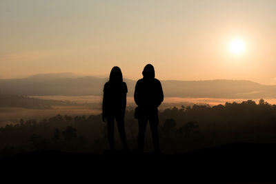 Silhouette of love guy and girl against sun in 2020