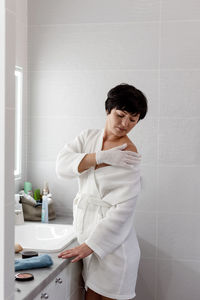 Side view of girl playing in bathroom