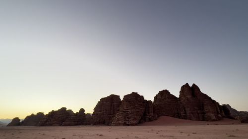 Rock formations on landscape against clear sky