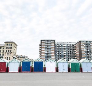 Houses on beach against sky