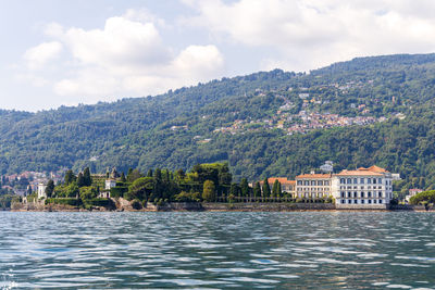 Scenic view of lake by mountains against sky