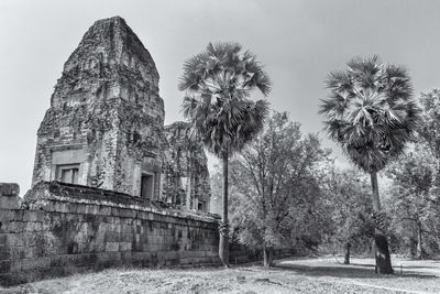 Historic temple by trees against sky