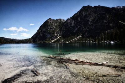 Scenic view of lake by mountains against sky