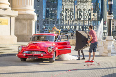 Red vintage car on street in city