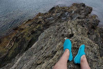 Low section of woman standing on rock