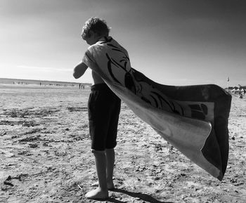 Full length of boy standing on beach