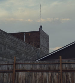 Low angle view of building against cloudy sky