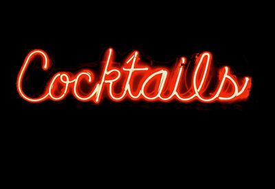 Illuminated cocktails text against black background