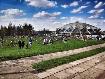 Group of people in park against sky