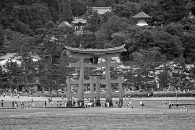 Group of people in park against buildings