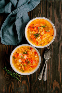 High angle view of soup in bowls on wooden table