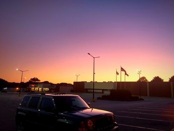 Cars on street at sunset