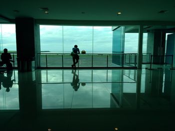 Silhouette people walking in airport