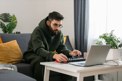 Young man using laptop at home