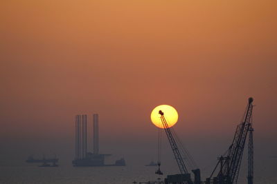 Scenic view of sea against an orange sky