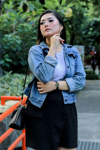 Portrait of young woman standing outdoors