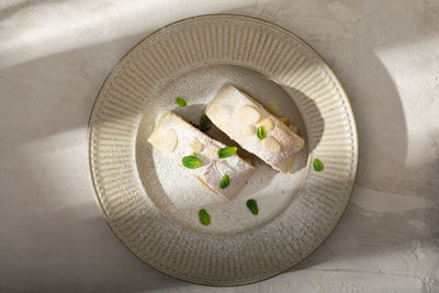 Close up of apple austrian strudel with cinnamon and mint on a plate