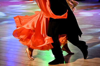 Low section of woman in traditional clothing dancing on street