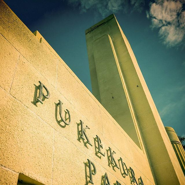 architecture, building exterior, built structure, low angle view, text, western script, communication, sky, city, building, modern, information, no people, capital letter, outdoors, day, office building, tower, tall - high, information sign