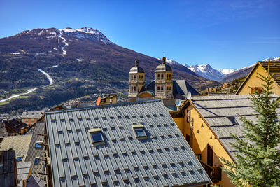 Buildings against clear blue sky during winter