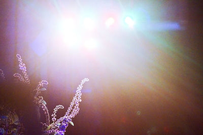 Close-up of illuminated bright sun against sky
