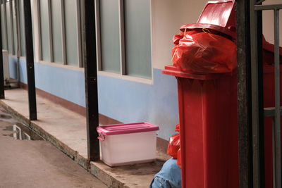 Red infectious waste bin inside the building. where garbage overflows out of the bin.