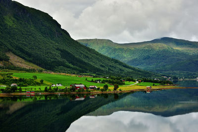 Scenic view of lake and mountains against sky