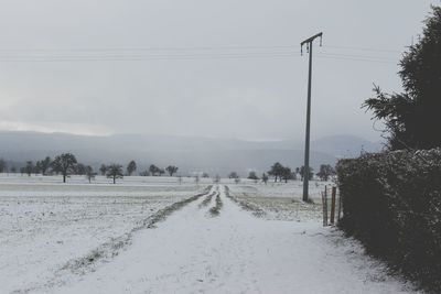 Scenic view of field against sky during winter