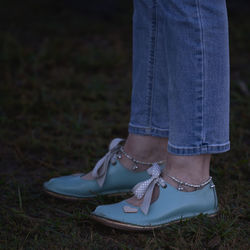 Low section of woman standing on grass