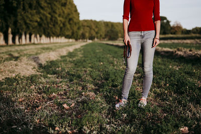 Low section of woman standing on land