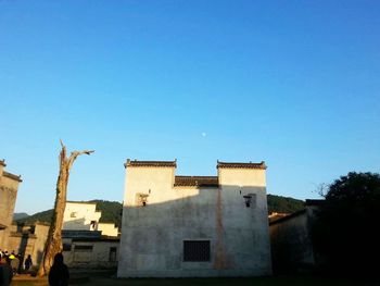 Low angle view of built structure against clear blue sky