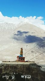 Scenic view of mountains against cloudy sky