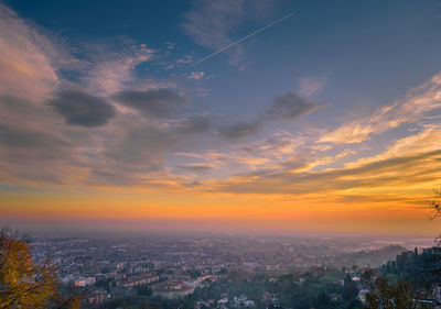 Aerial view of cityscape against sky during sunset