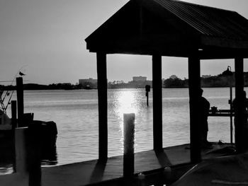 Silhouette pier on sea against sky