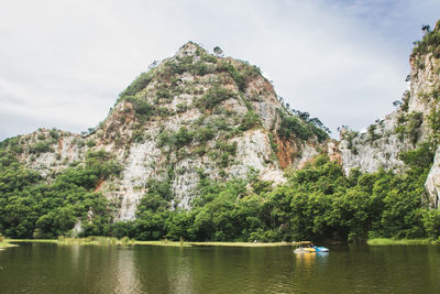 Scenic view of river and mountains against sky